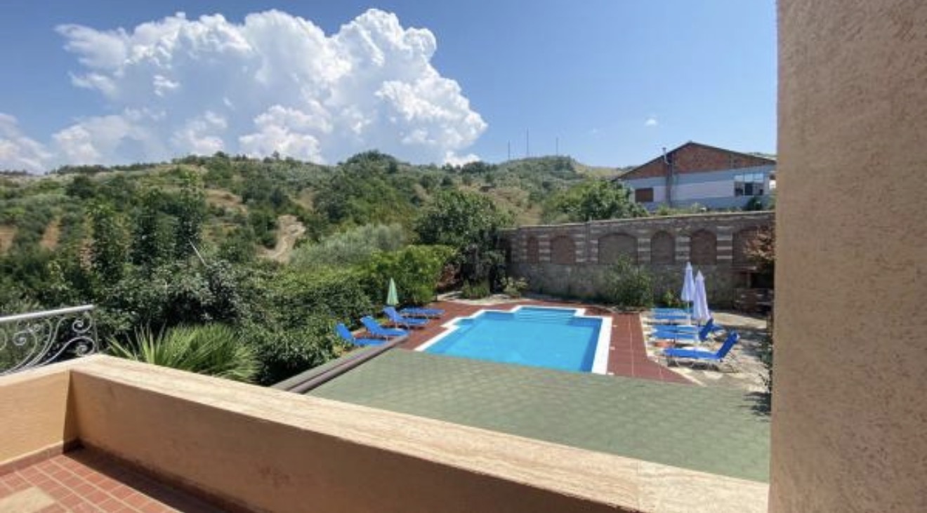 Loungers, blue water and green hills in every direction.